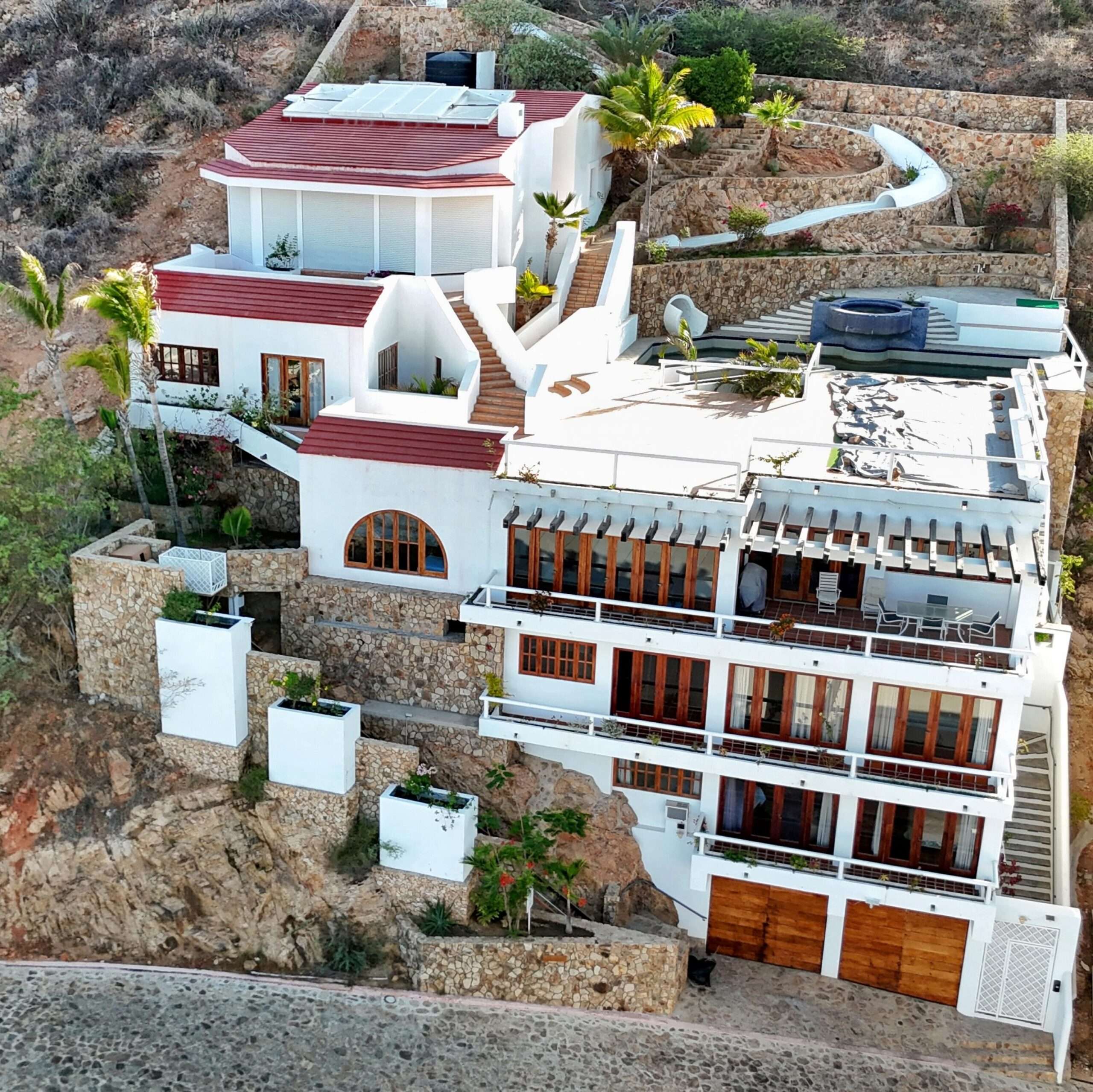 Cabo Luxury Pedregal Csl Perched high above the marina and the Sea of Cortez, this extraordinary 10,000-square-foot estate is one of Pedregal's most iconic residences. Carved into the granite hillside, the property represents a remarkable piece of Cabo San Lucas history and offers an architectural experience unlike any other in Los Cabos.Panoramic – 115 Cam. Grande, Cabo San Lucas, BS