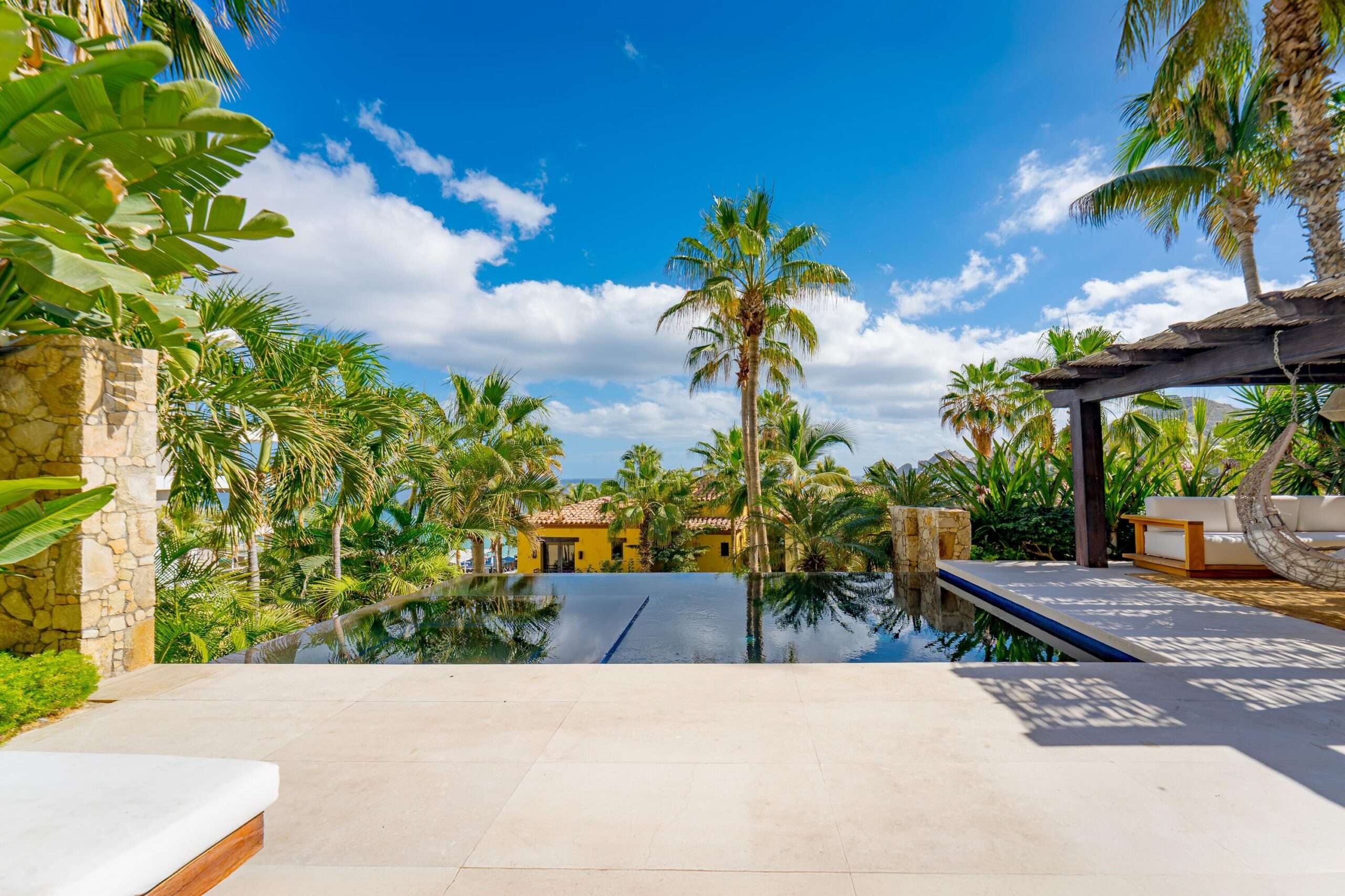 Cabo Luxury Hacienda Csl This fully renovated three-bedroom property offers a seamless indoor-outdoor layout designed for comfortable coastal living.The private terrace features a pool, hot tub, BBQ area, and a dedicated outdoor bar, complemented by a shaded lounge and seating area surrounded by mature landscaping, ideal for entertaining or everyday relaxation. The ground-level setting allows easy access to outdoor spaces while maintaining privacy. Inside, the residence has been completely updated with clean, modern finishes and a functional floor plan. Bedrooms are well sized and thoughtfully distributed for both owners and guests. The layout includes a family suite / additional sleeping space (bunk room or flex sleeping area), allowing accommodation for up to 8 guests, offering greater flexibility than the typical 3-bedroom layout designed for six.Set in one of the most desirable areas of Cabo San Lucas, the property enjoys direct beach access and close proximity to the marina, restaurants, and services, all within the Hacienda Beach Club community. – 1102 Beachfront Hacienda, Cabo San Lucas, BS